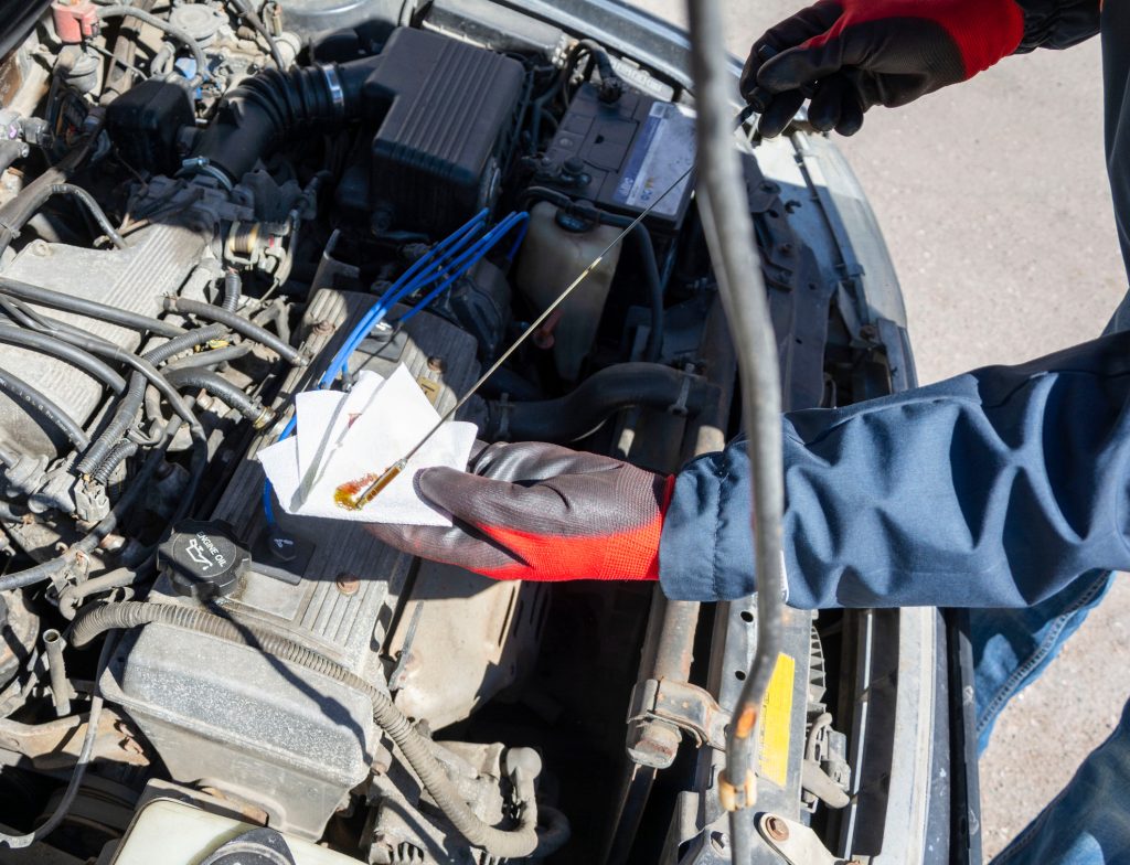 Technician diagnosing rough idle and excessive oil consumption