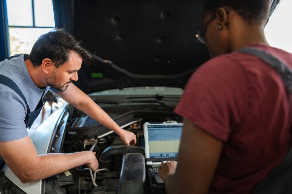 A student learning engine diagnostics during automotive training