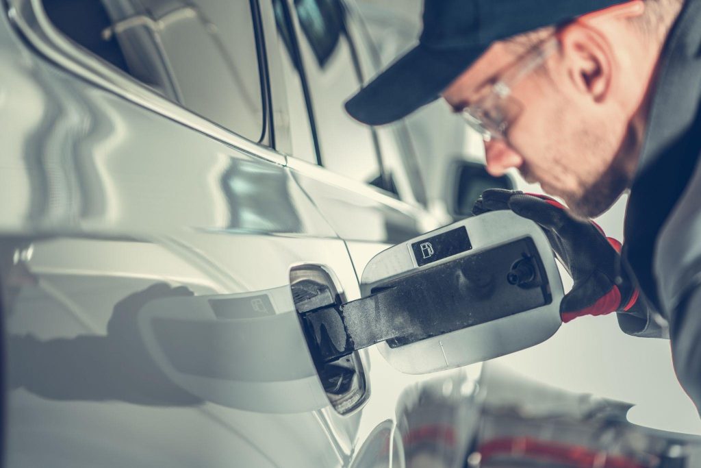 Plug-in hybrid vehicle fuel and electrical systems being inspected