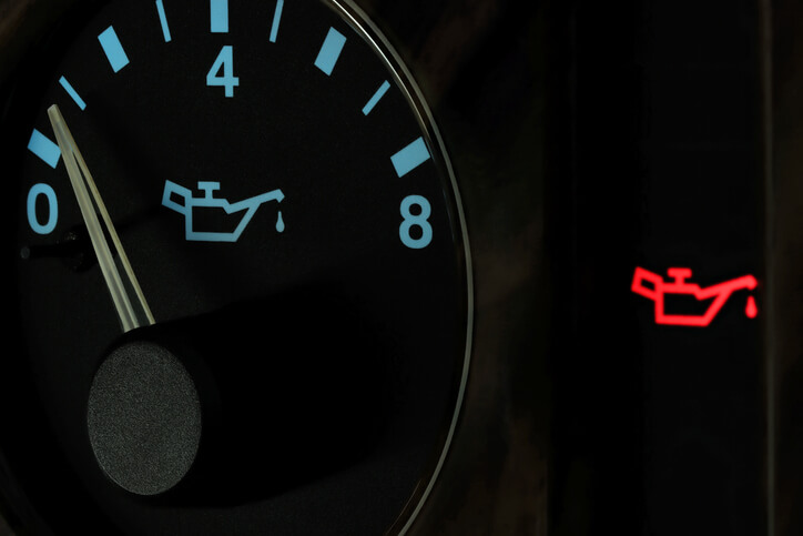 A dashboard showing an illuminated oil-pressure warning light