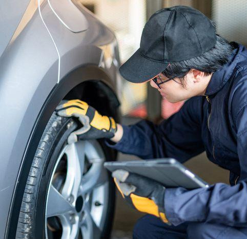 A Mechanic checking a tire and wheel after a hard pothole impact