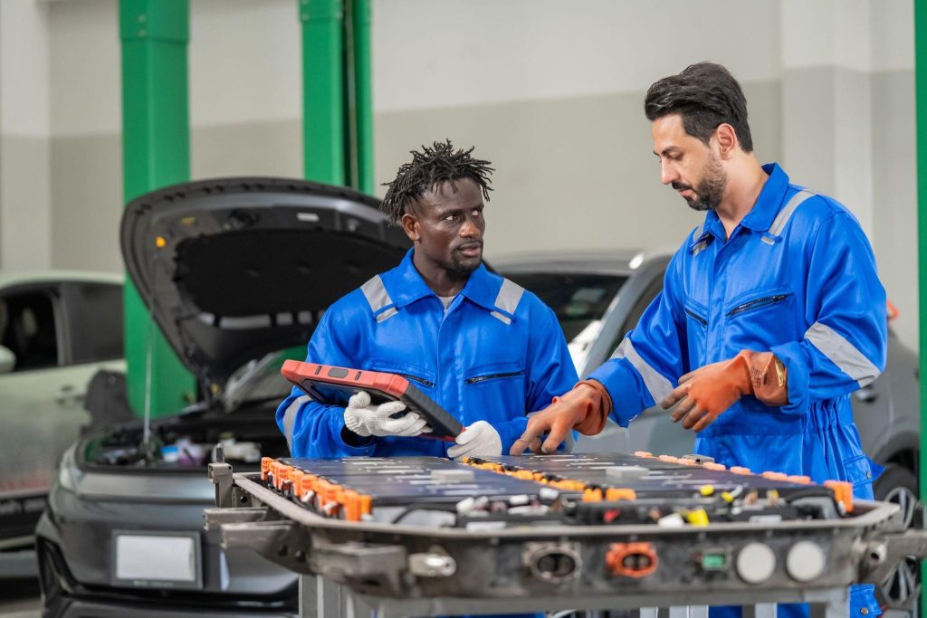 A technician learning about the Genesis GV90 battery and high-voltage EV systems