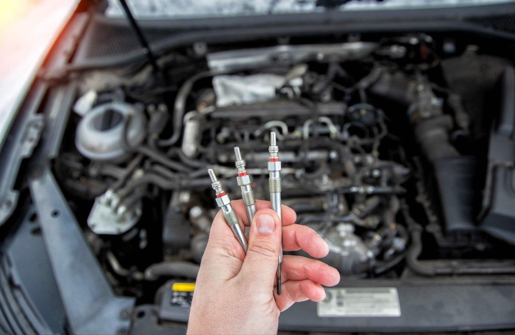A technician testing bad glow plug symptoms during a cold-start diagnosis