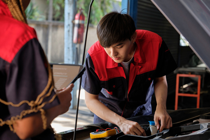 Technician inspecting an engine block heater before cold weather