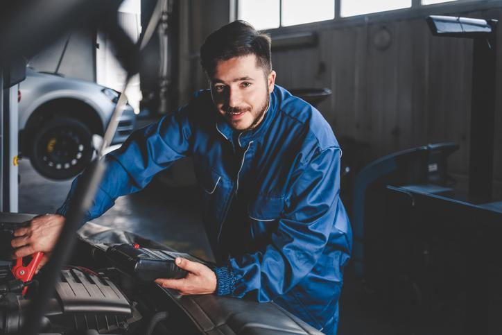 Student testing a blower motor electrical circuit during auto mechanic training