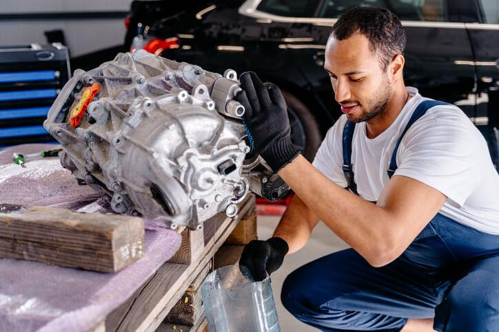 A technician inspecting a transfer case before winter driving in Surrey
