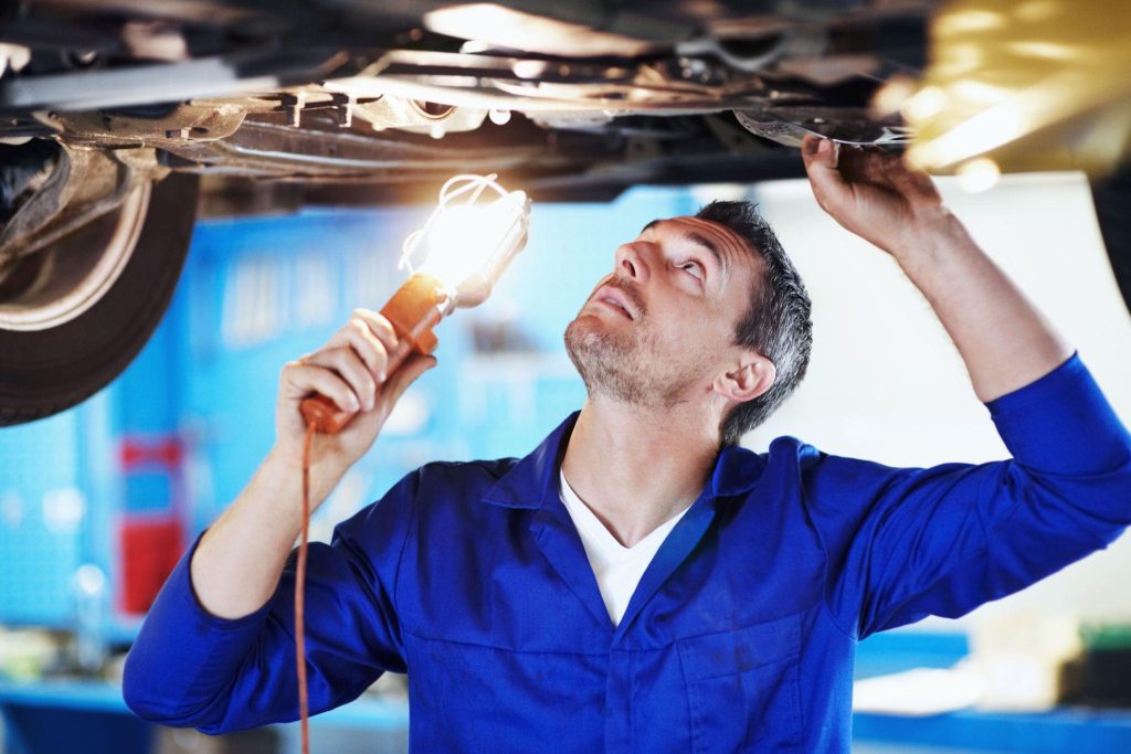 An automotive student inspecting an EVAP leak detection pump