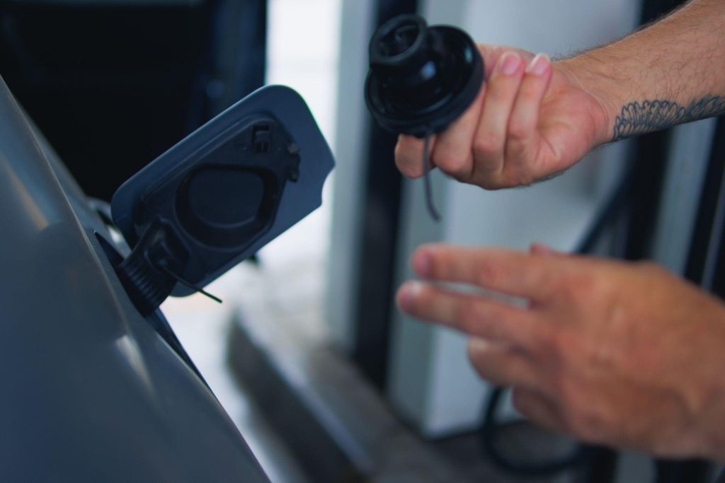 A technician inspecting a fuel cap and filler seal during EVAP leak diagnosis
