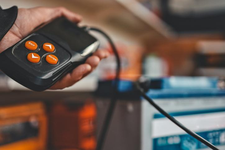 A technician using a diagnostic scan tool to investigate an engine trouble code