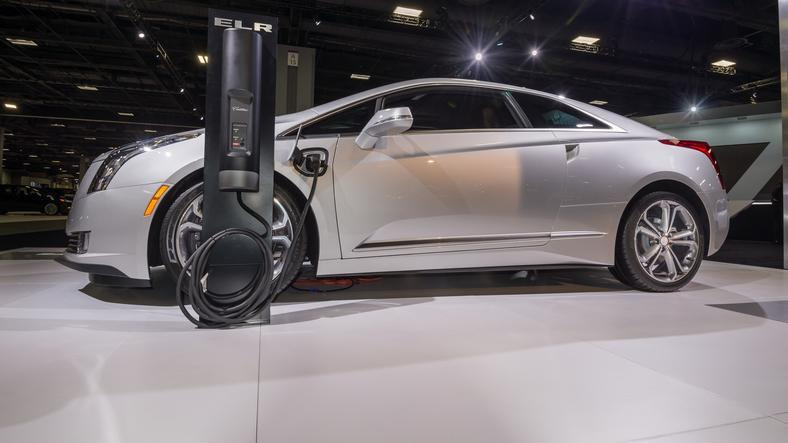 An electric vehicle plugged into a DC fast charging station