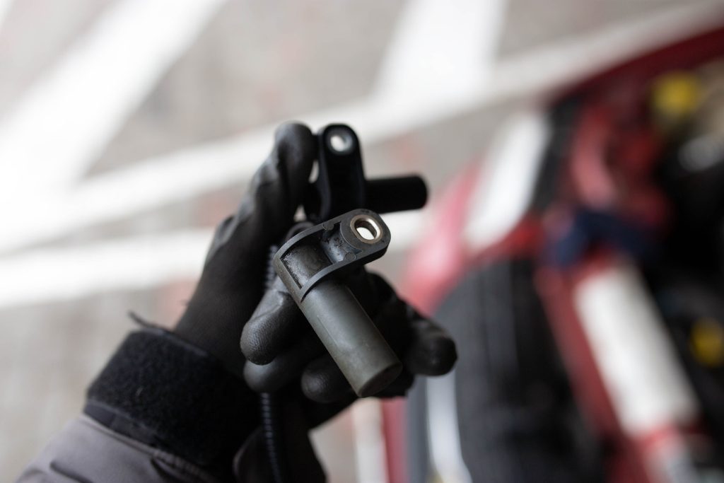 A future technician inspecting crankshaft sensor wiring during a no-start diagnosis.
