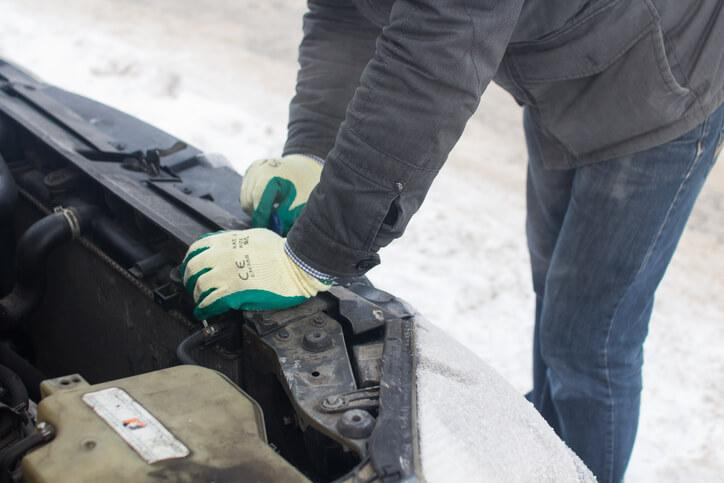 A technician checking an electric vehicle heater during cold-weather diagnostics