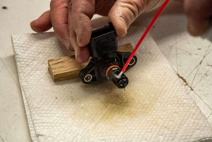 A technician testing a manifold absolute pressure sensor electrical circuit