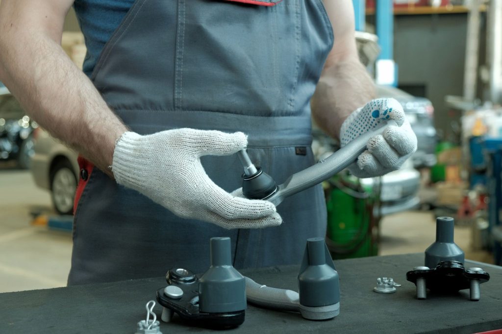 A technician inspecting steering components during a steering-angle sensor diagnosis